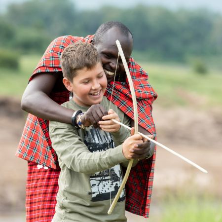 Learning how to shoot a bow and arrow at Governors Camp in the Masai Mara